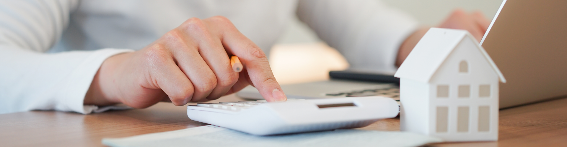 A person's hand on a stack of white cubes.