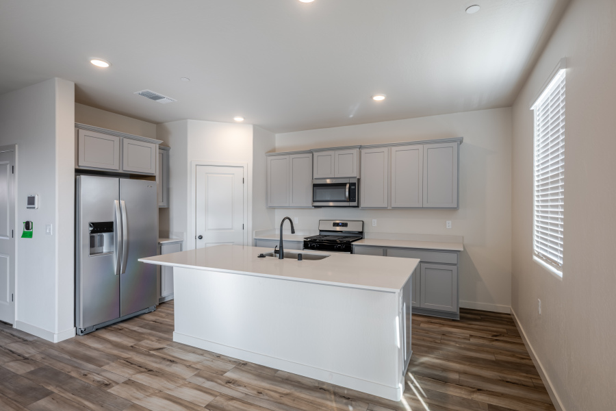 A kitchen with white cabinets.