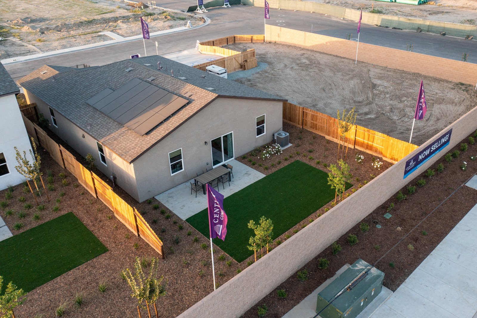A house with a lawn and a parking lot.