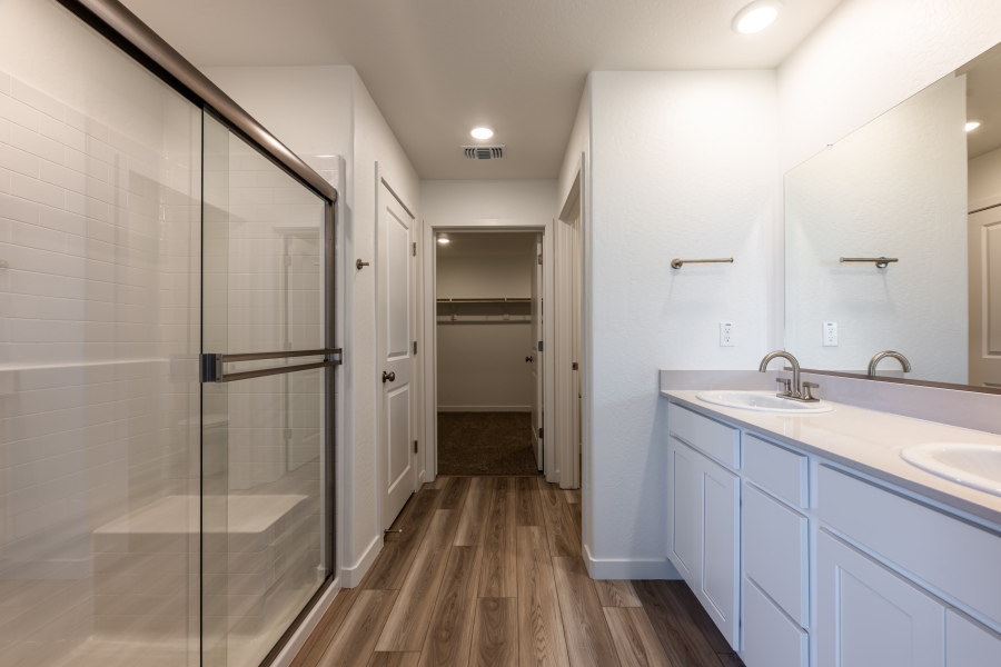 A bathroom with white cabinets.