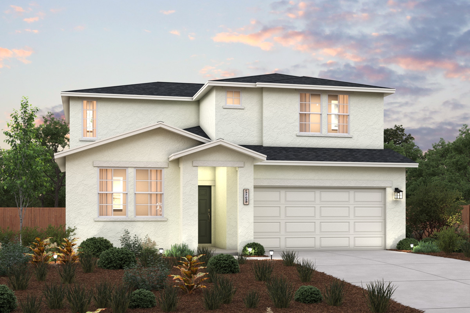 A house with a garage and bushes in front of it.