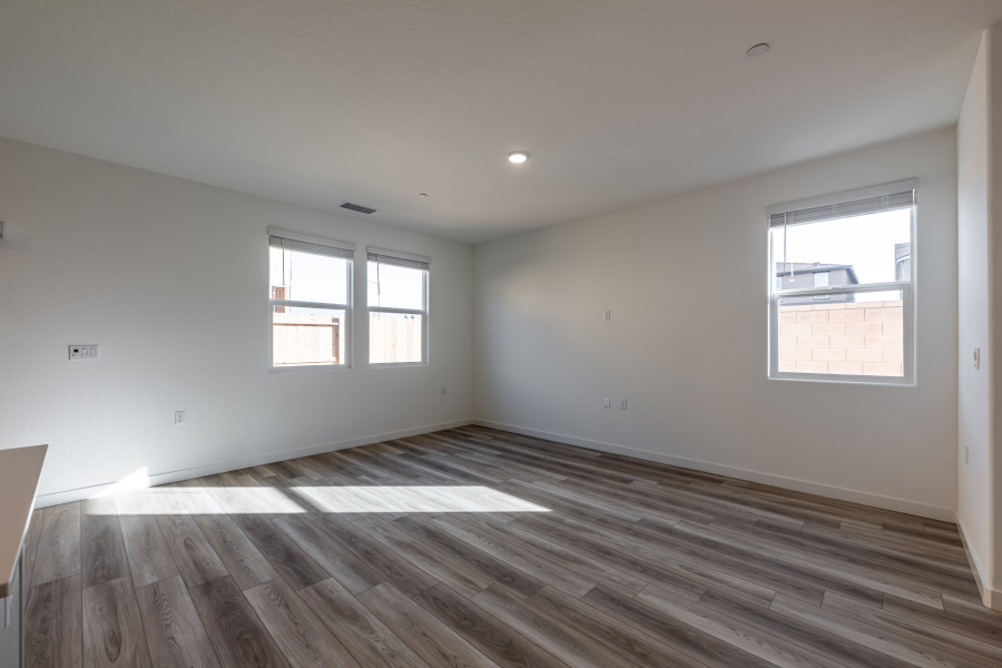 A room with windows and wood floor.