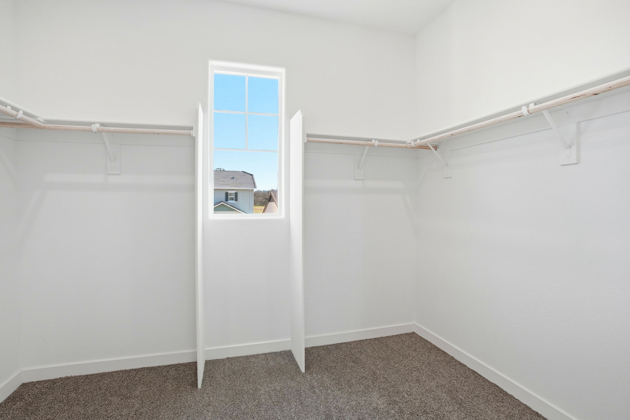 A room with a window and a bed.