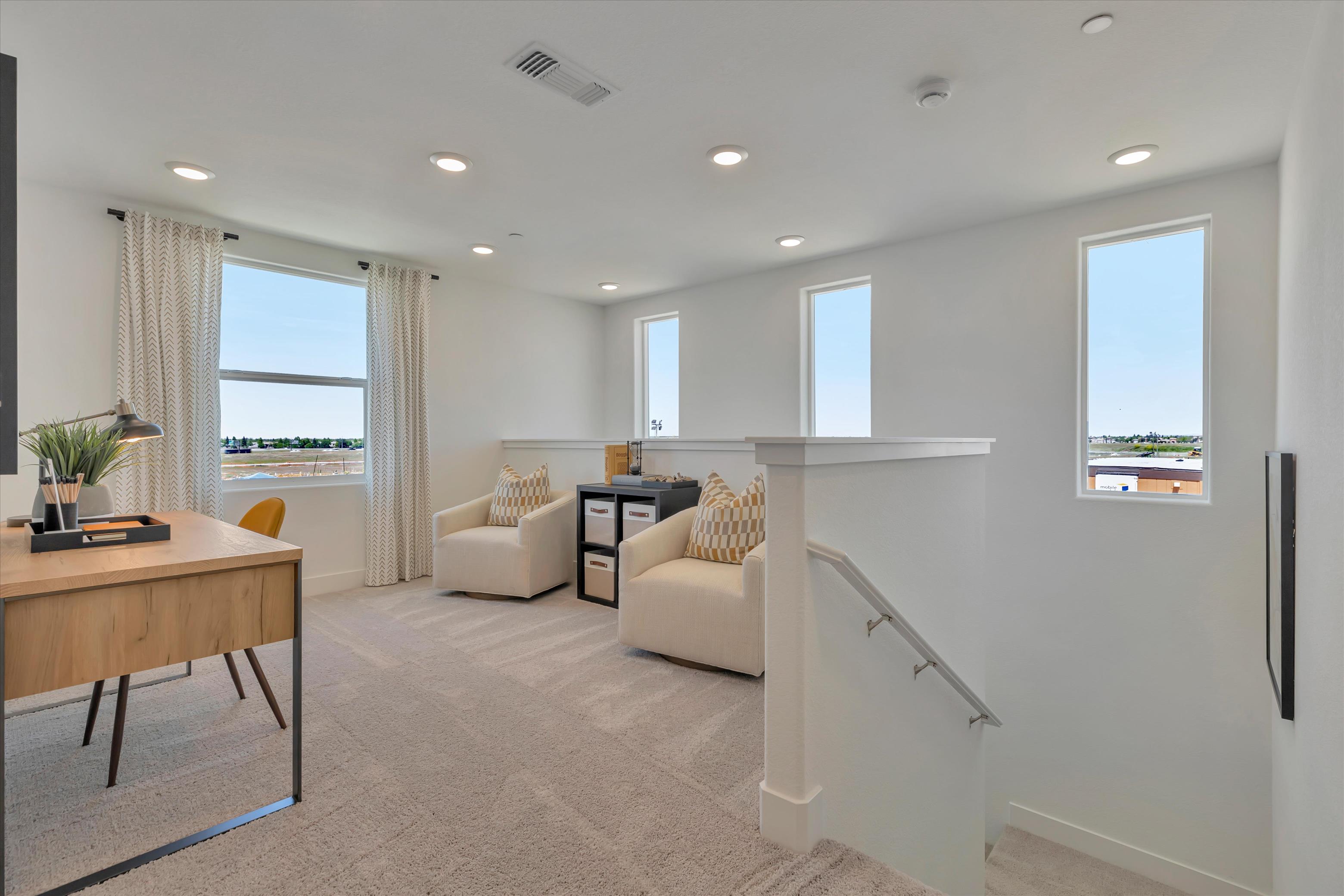 A living room with a table and chairs.