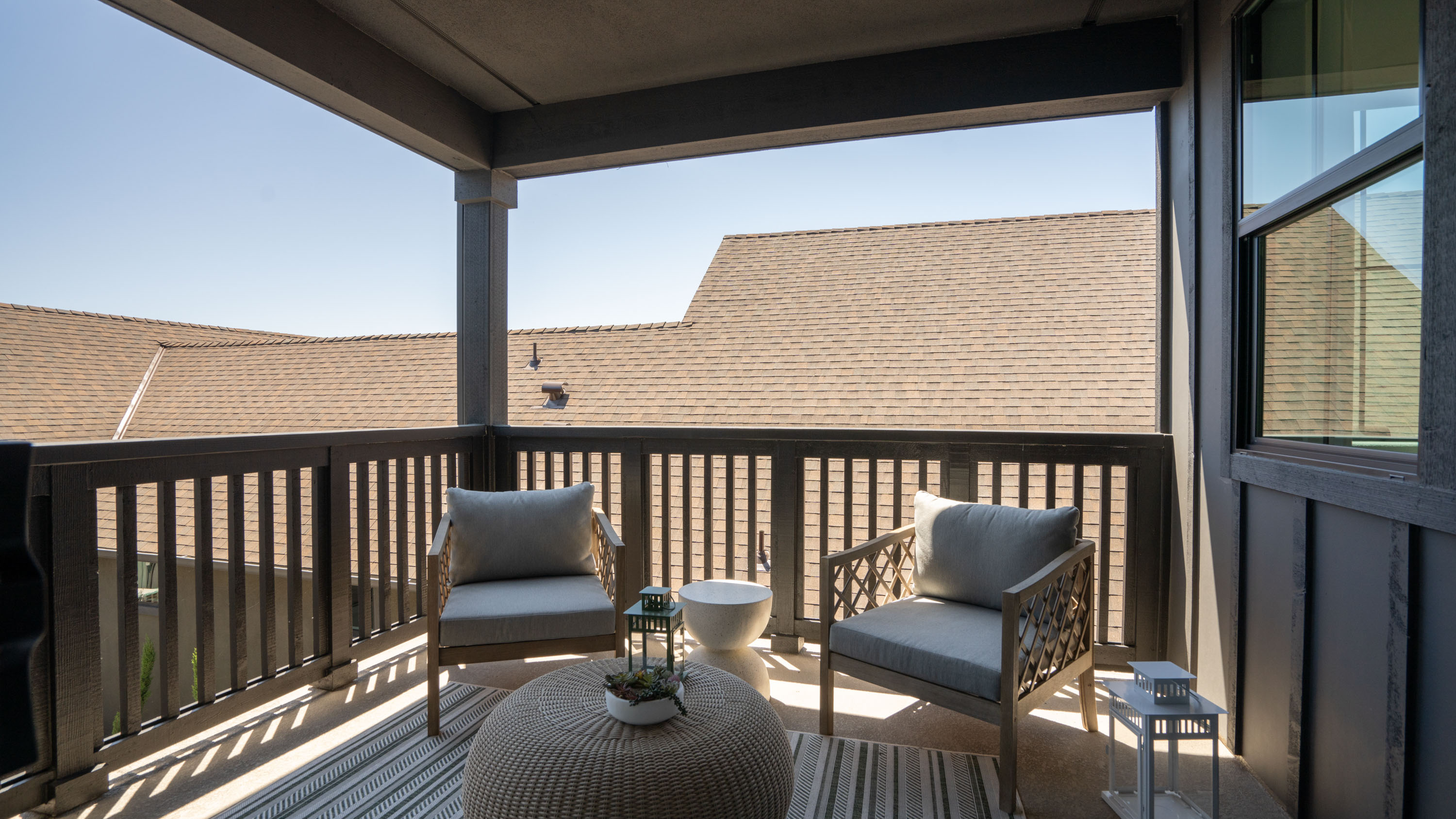 A deck with chairs and a table.