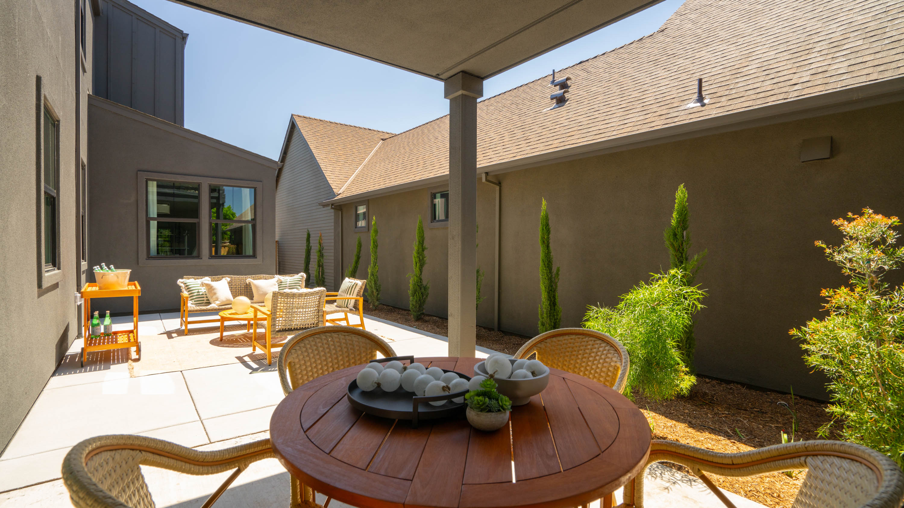A patio with a table and chairs.