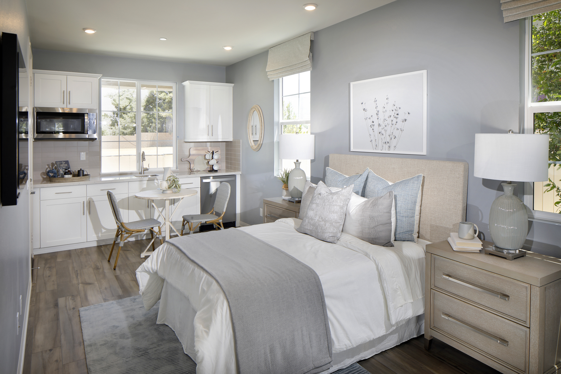 A bedroom with a bed and a table.