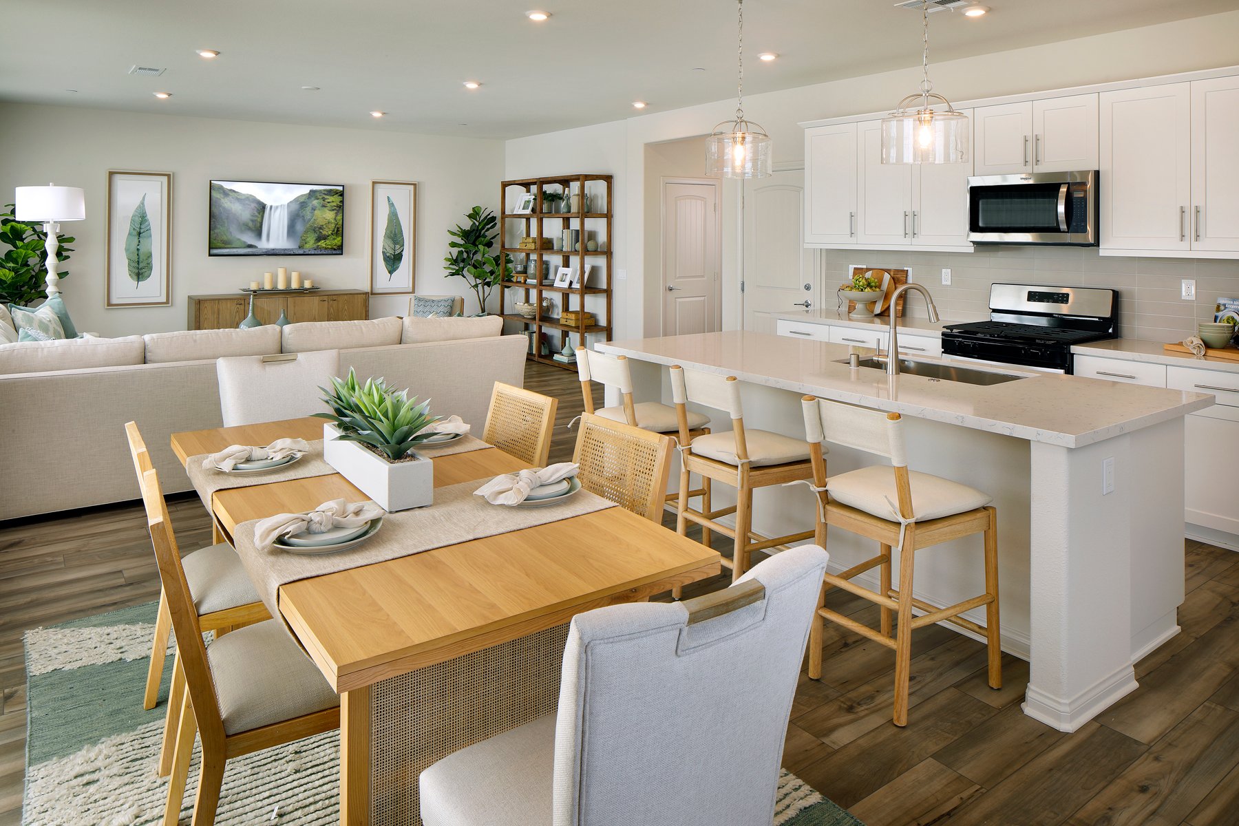 A kitchen with a dining table and chairs.