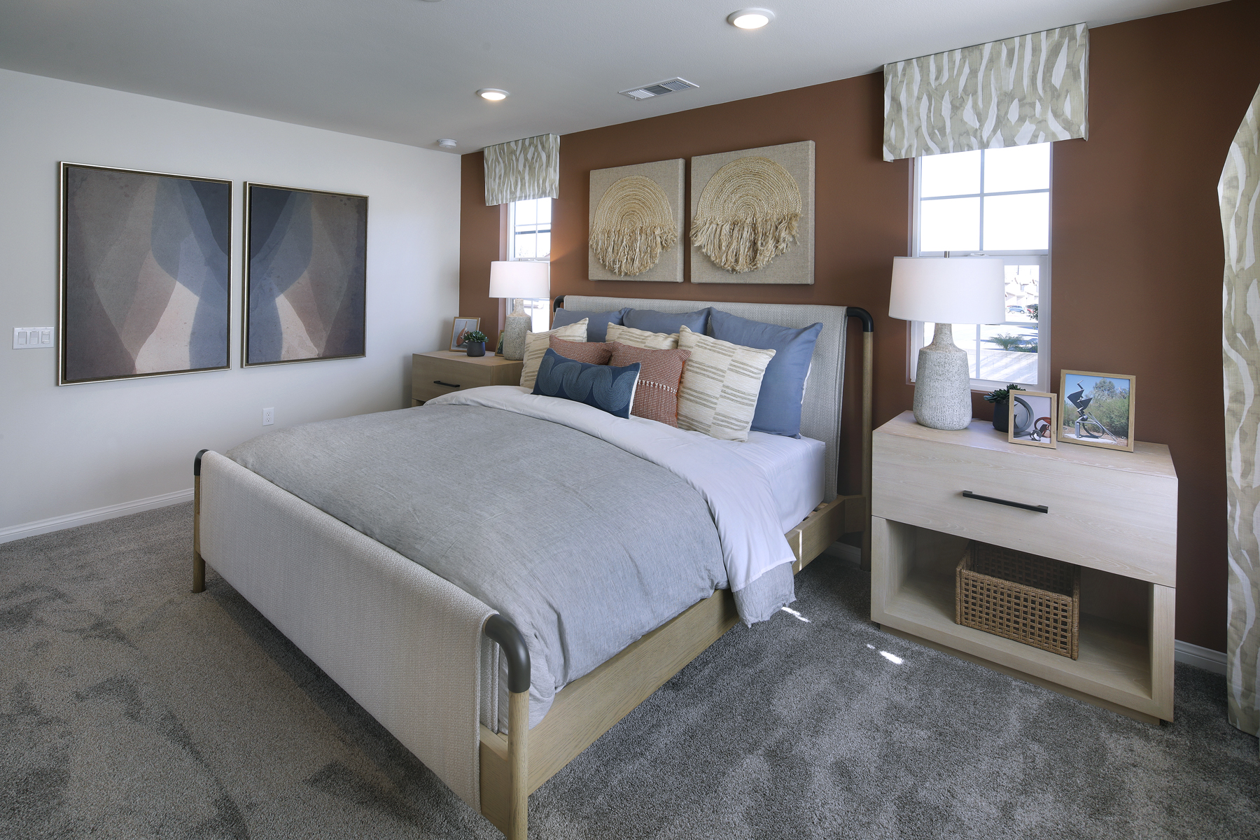 A bedroom with a bed and lamps.