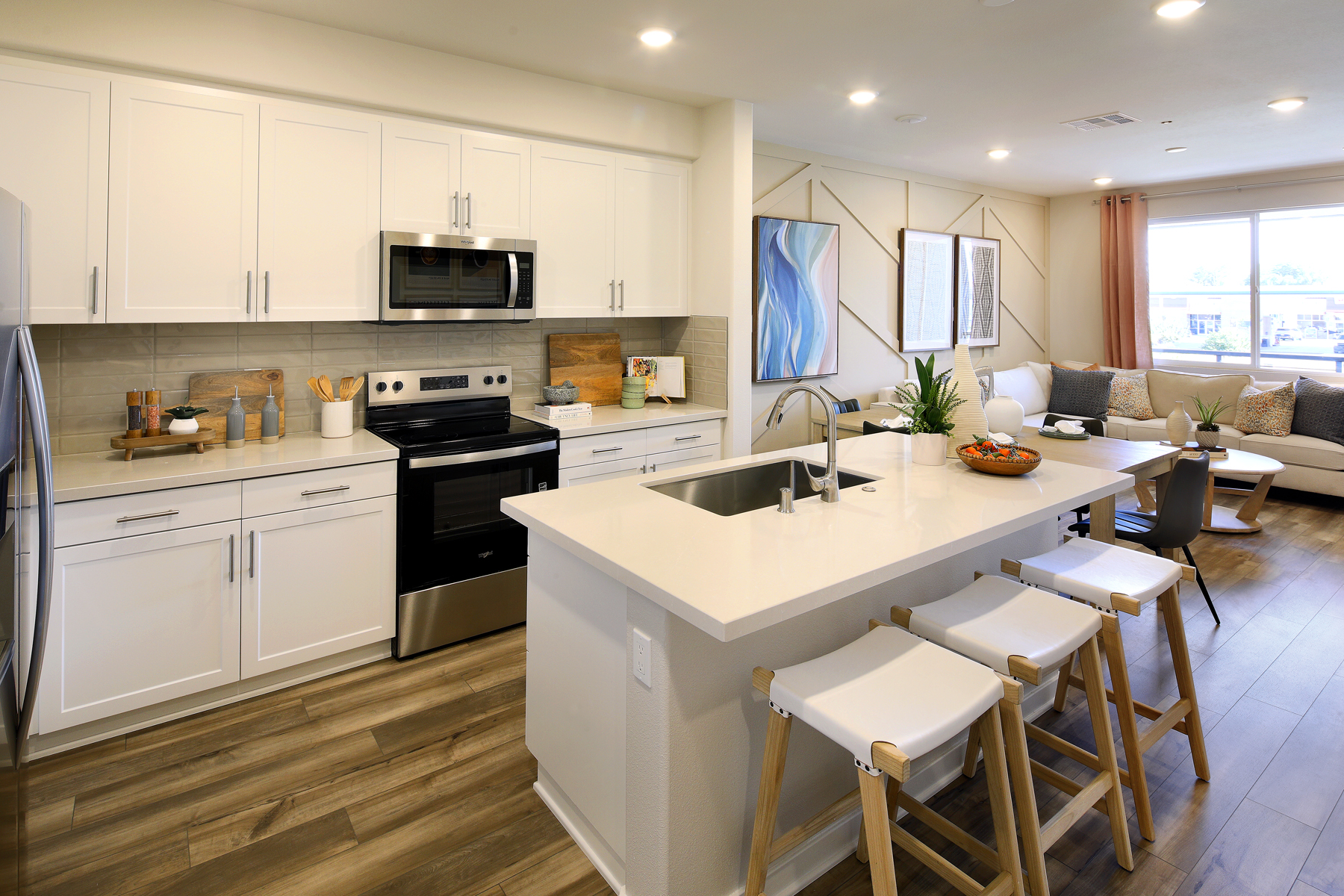 A kitchen with white cabinets.
