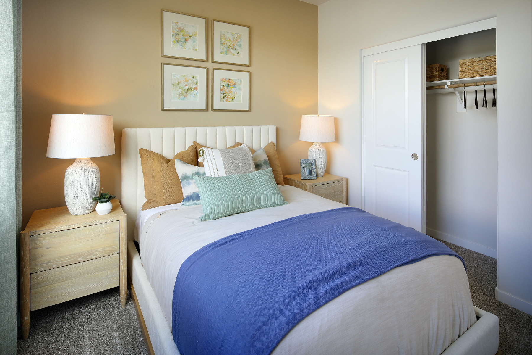 A bed with a blue comforter.