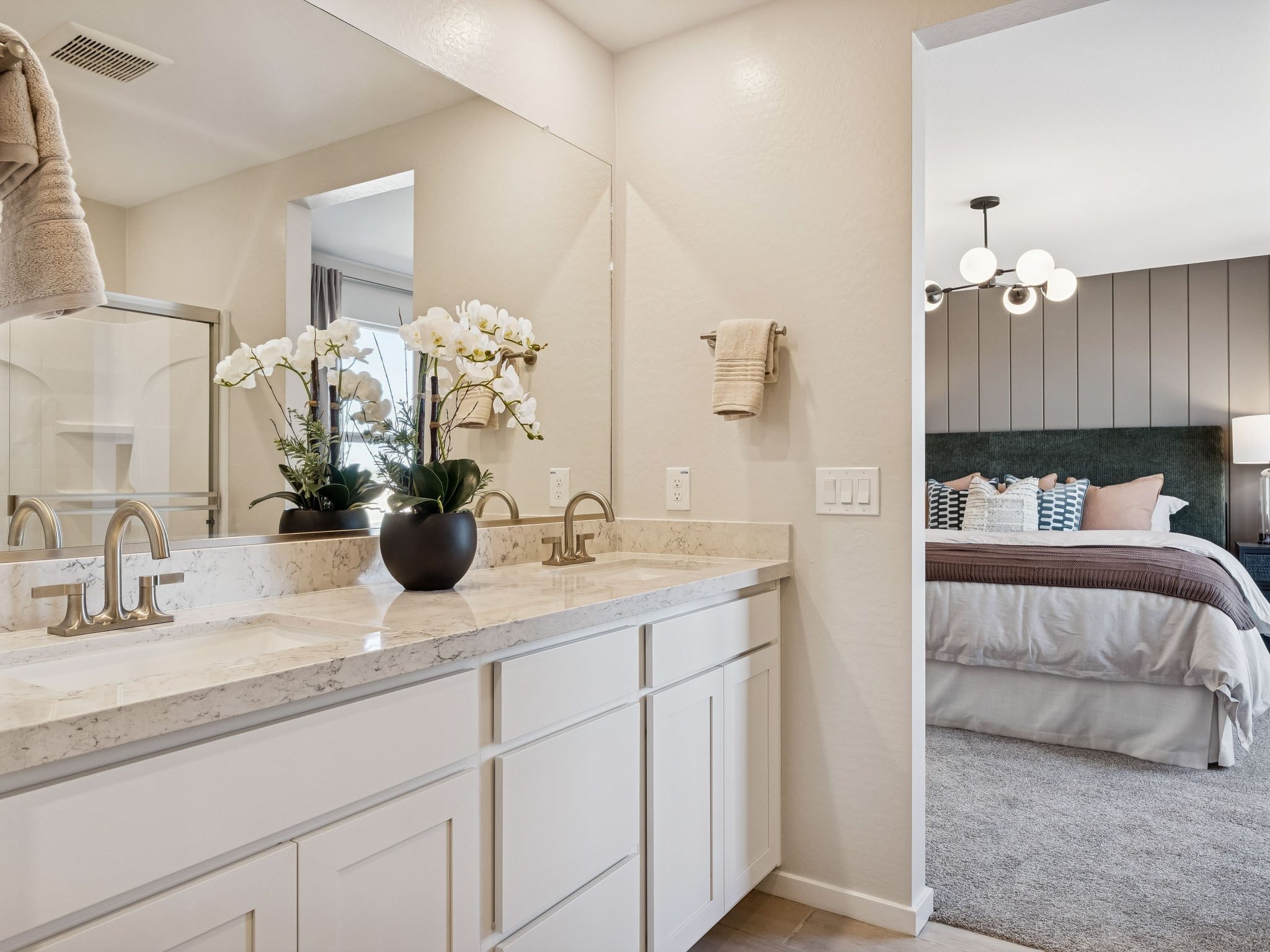A bathroom with a tub sink and mirror.