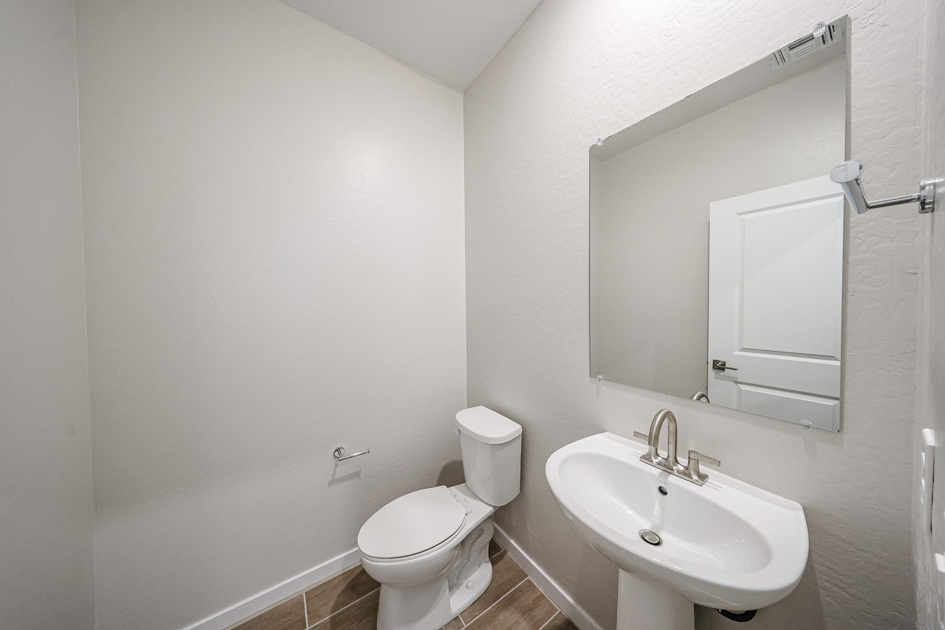 A bathroom with a toilet and sink.