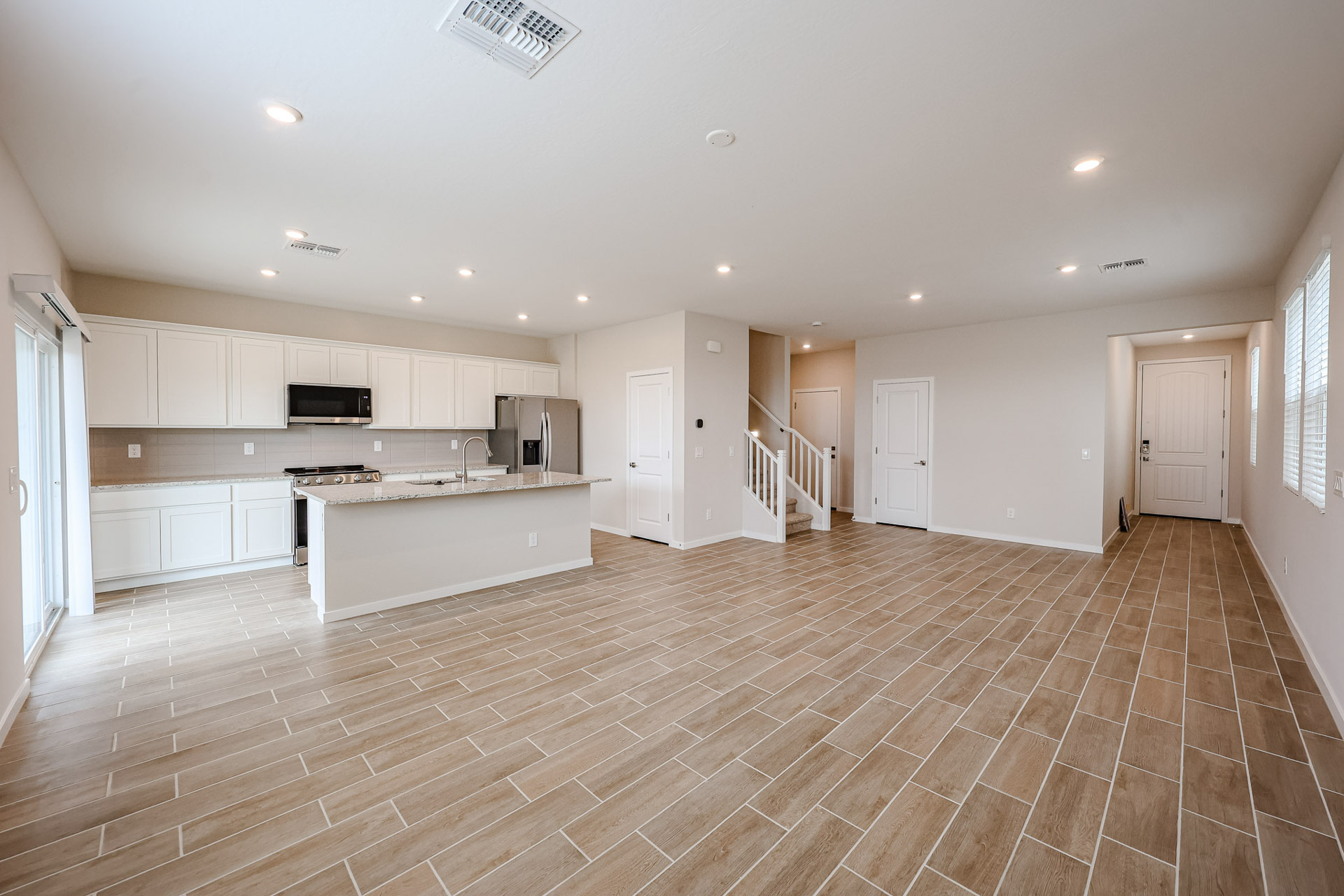 A large kitchen with white cabinets.