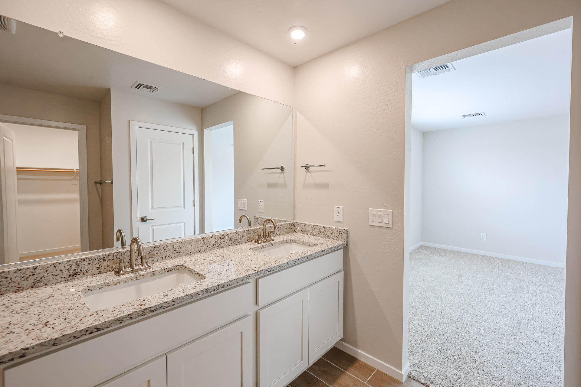A bathroom with a large mirror.