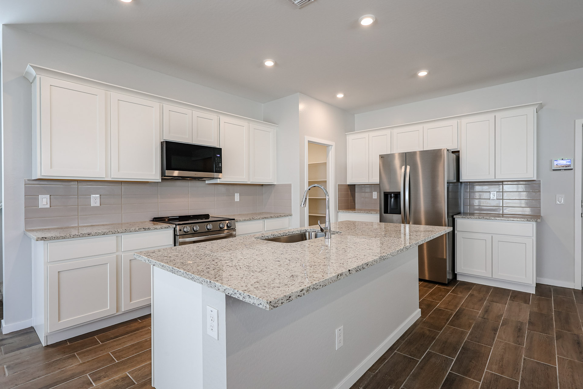 A kitchen with white cabinets.