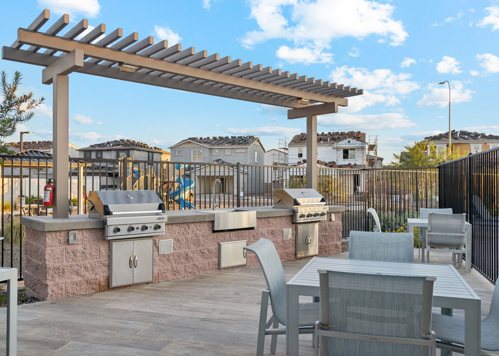 A patio with tables and chairs.