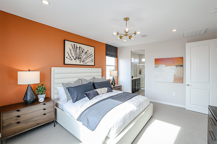 A bedroom with a bed and lamps.