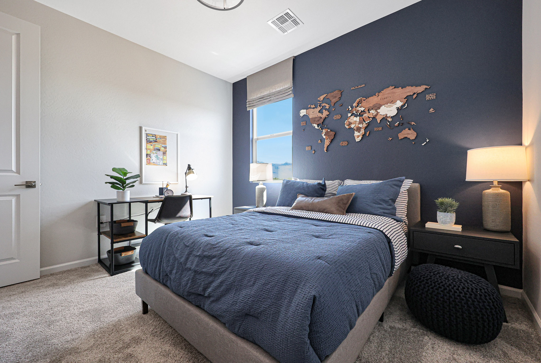 A bedroom with a bed and a desk.