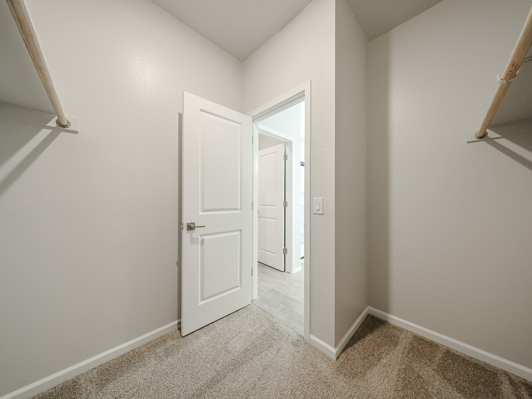 A hallway with white doors.