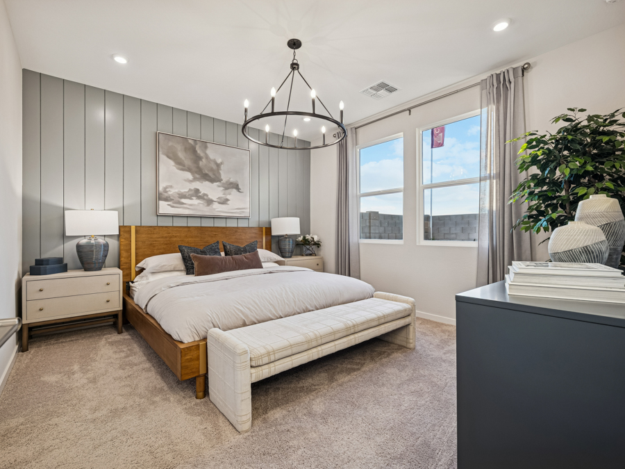 A bedroom with a bed and a lamp.