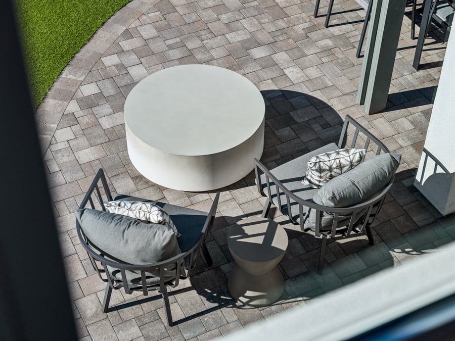 A patio with a table and chairs.