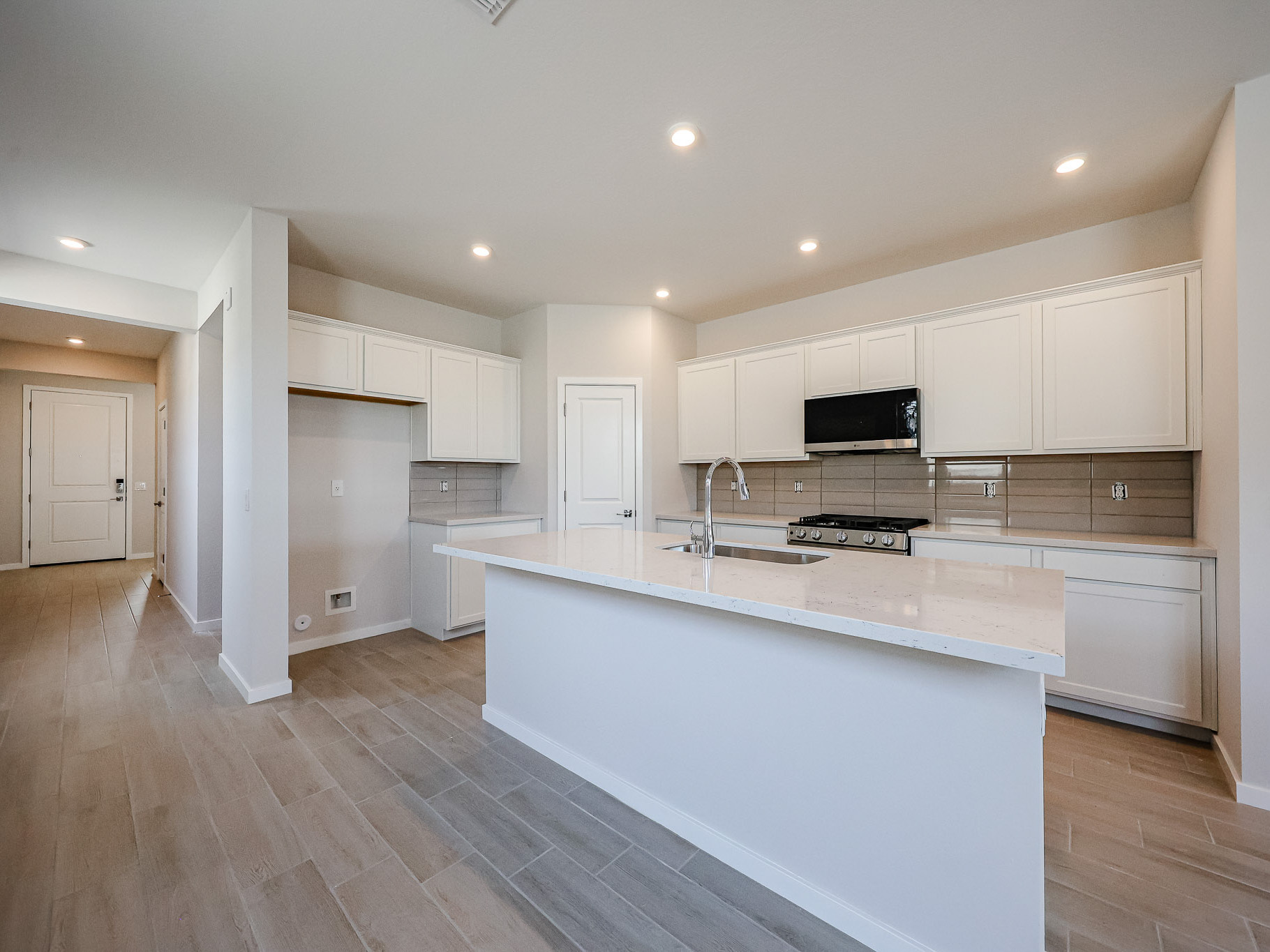 A kitchen with white cabinets.
