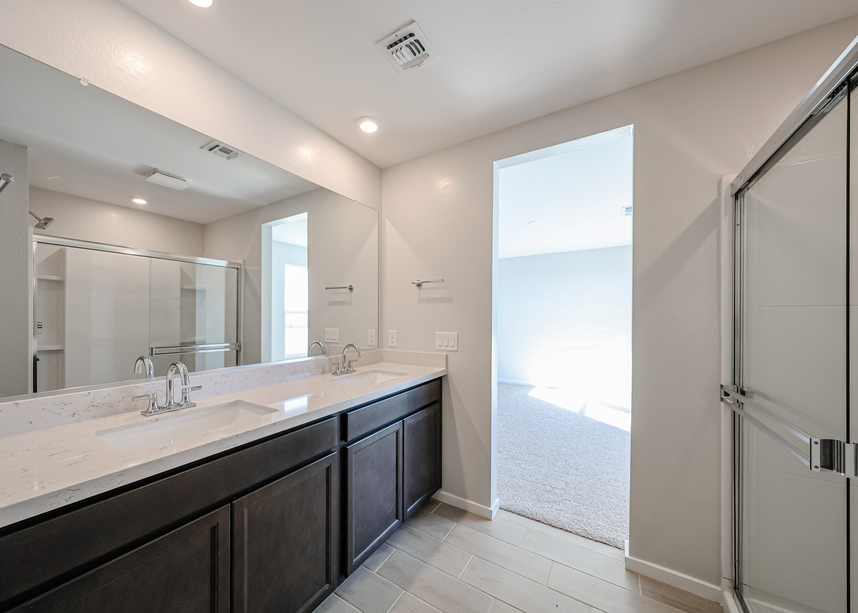 A bathroom with a large mirror.
