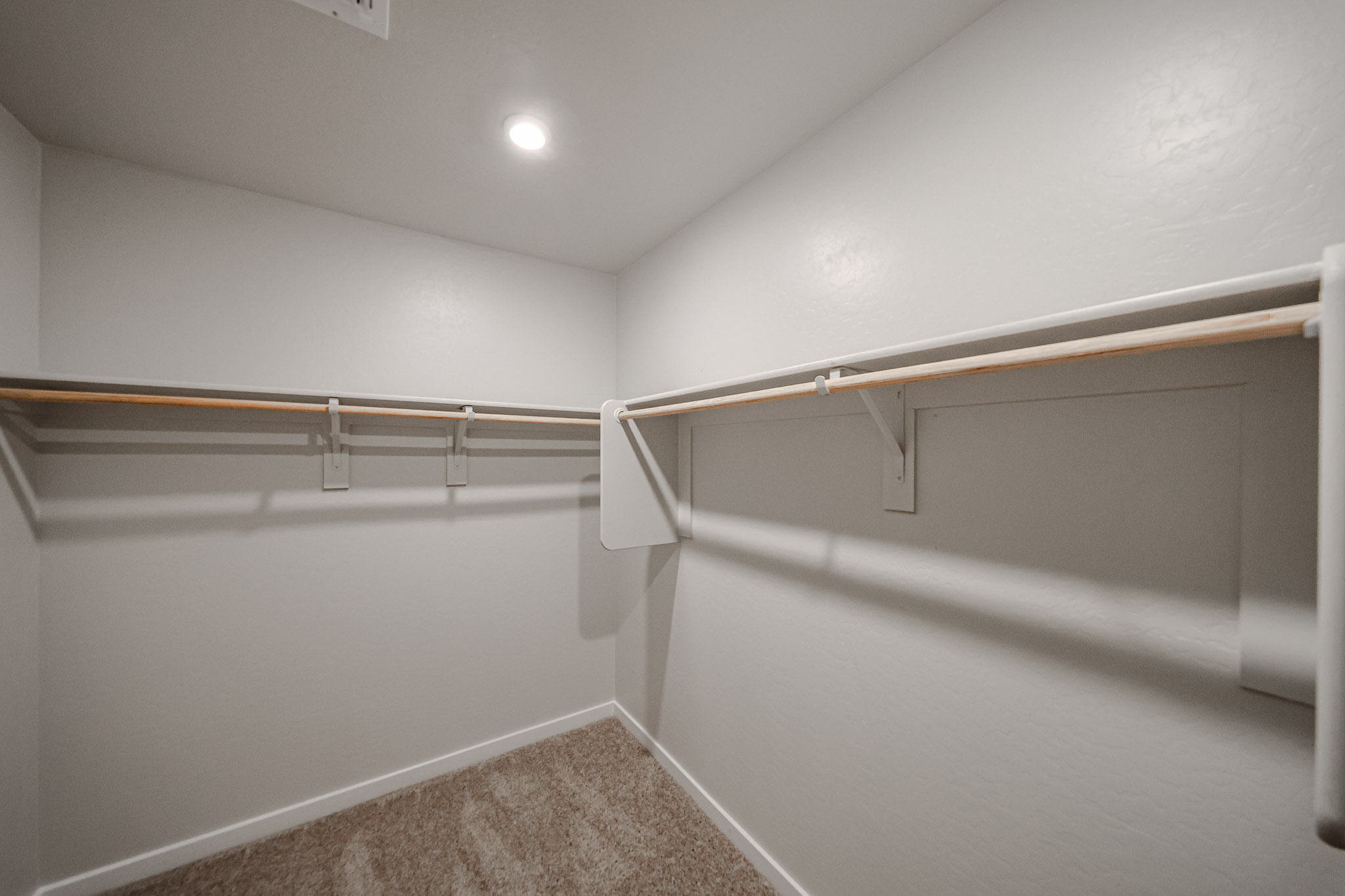 A white wall with a metal railing.