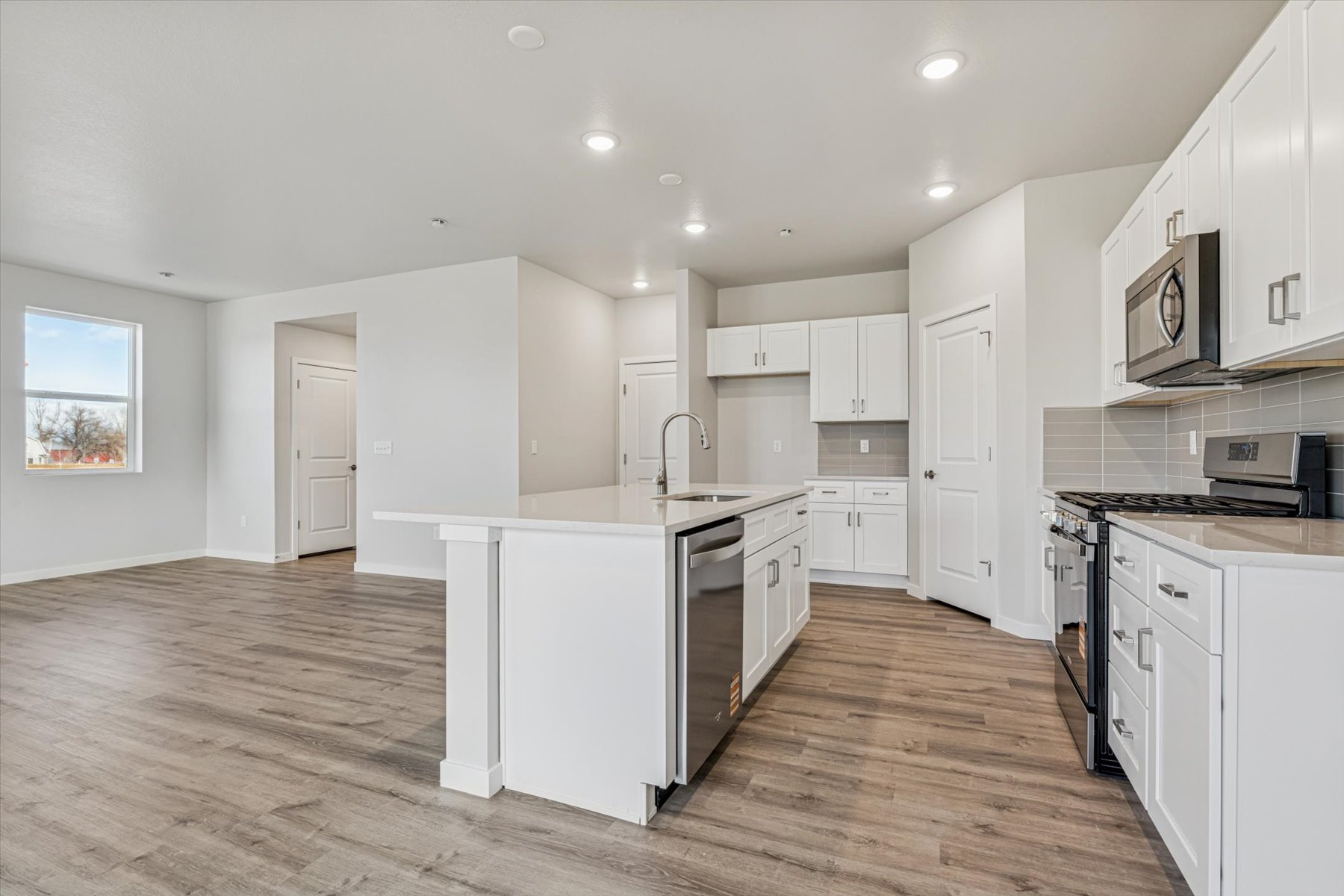 A kitchen with white cabinets.