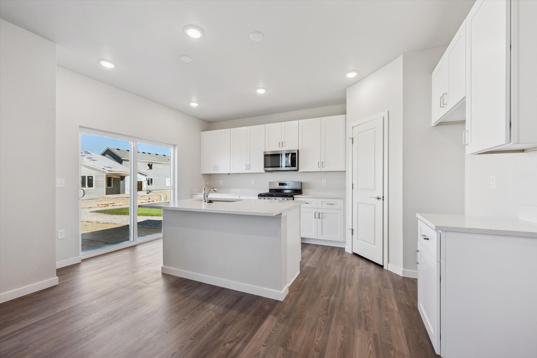 A kitchen with white cabinets.