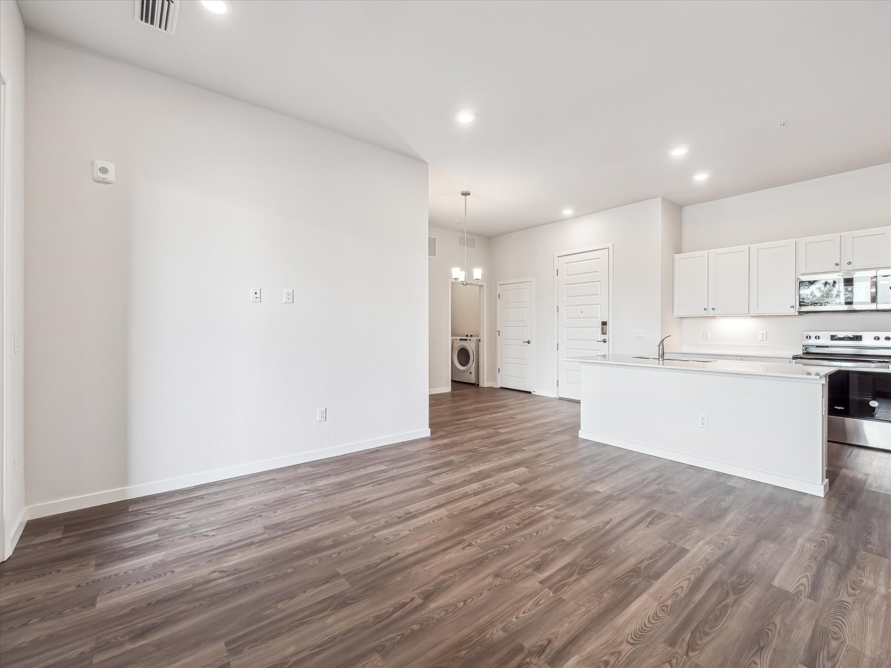 A large kitchen with white cabinets.