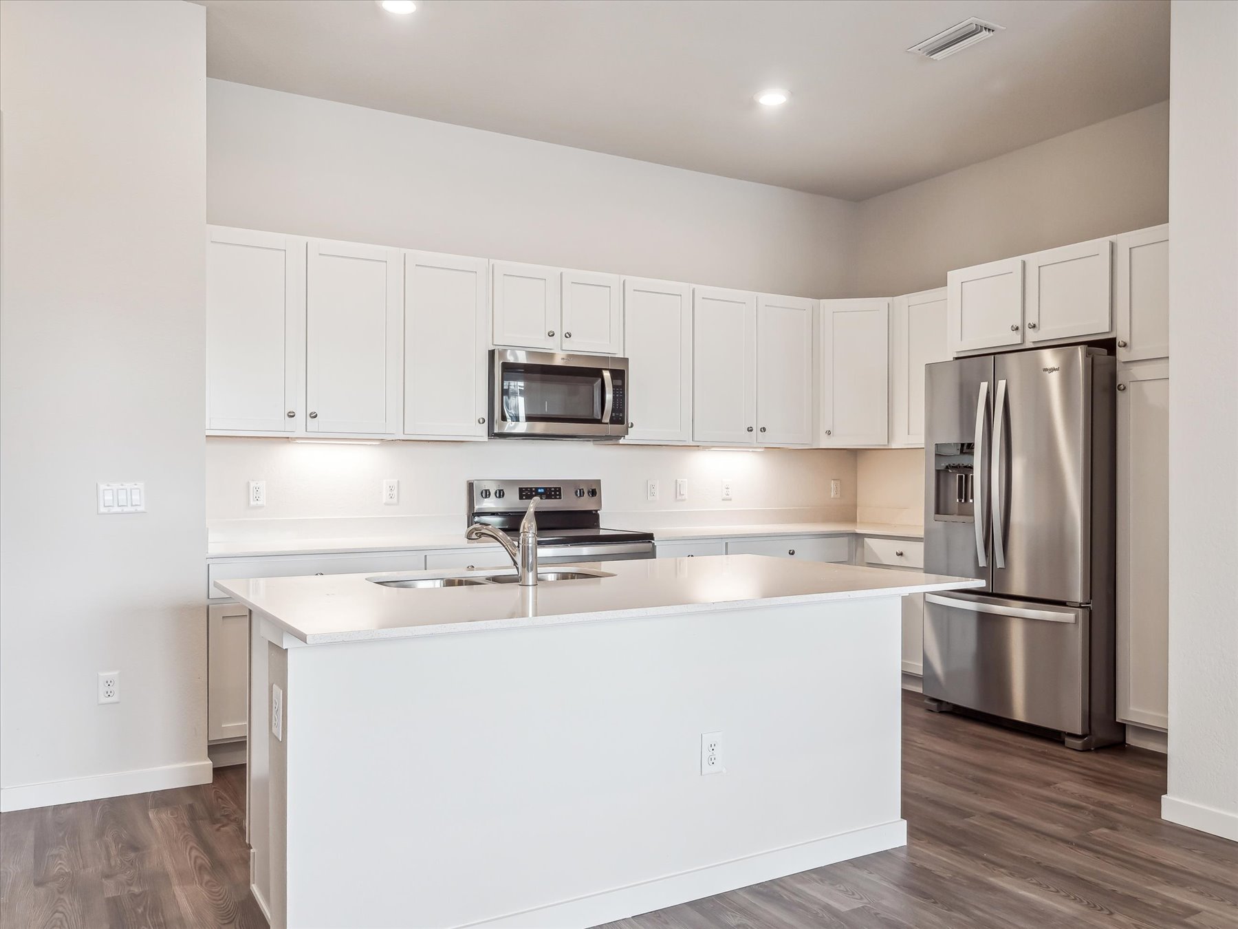 A kitchen with white cabinets.