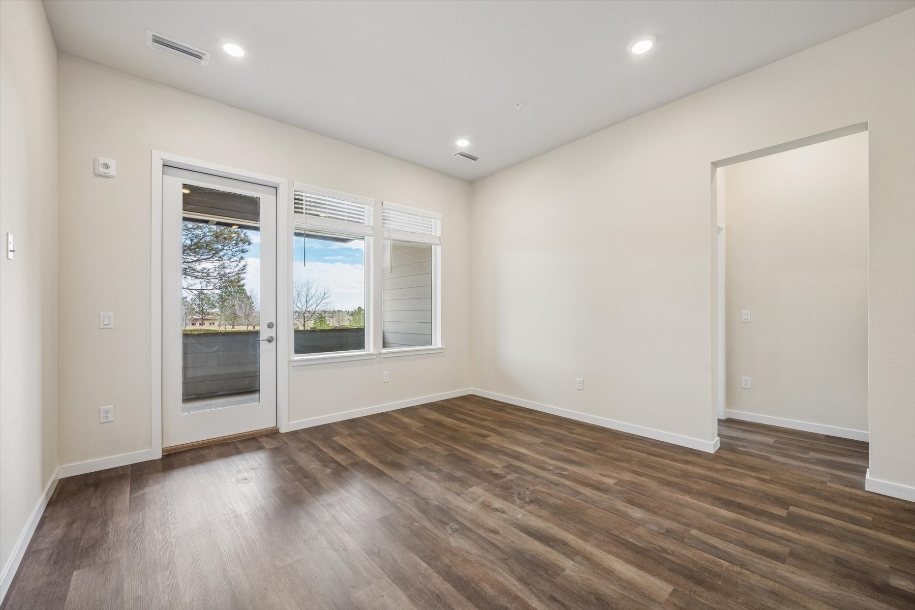 A room with a wood floor and white walls.