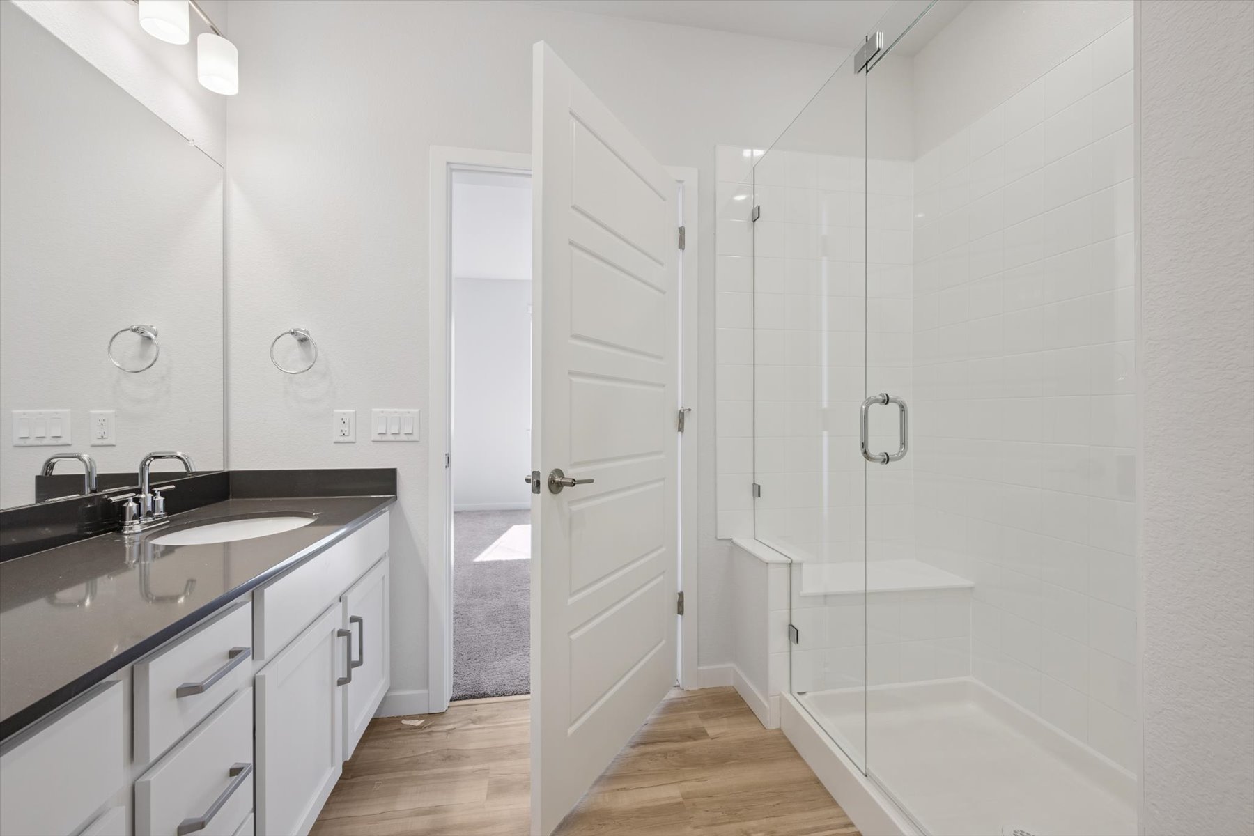 A bathroom with a sink and a shower.