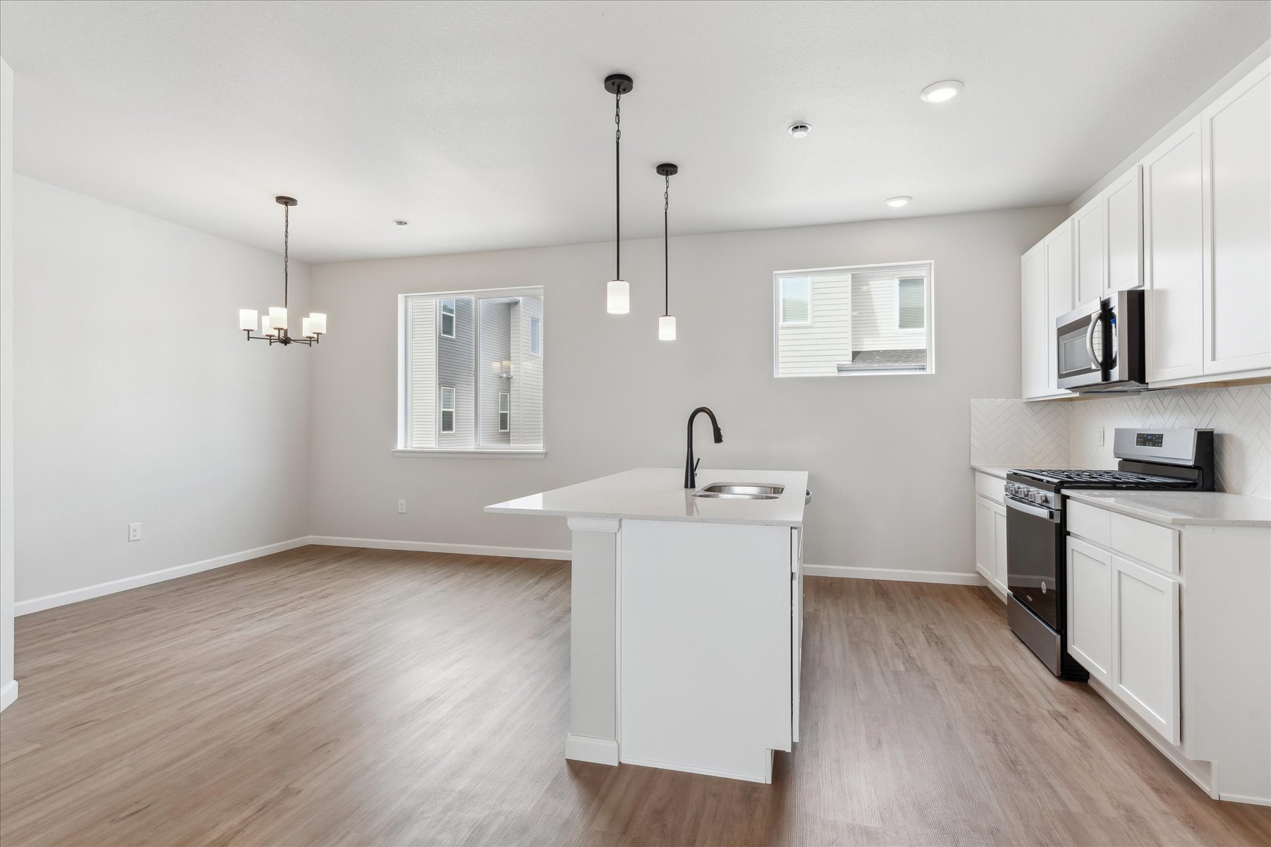 A kitchen with white cabinets.