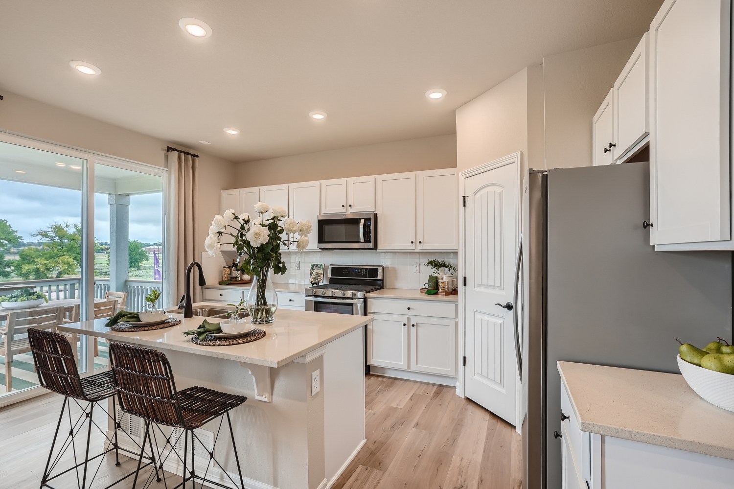 A kitchen with white cabinets.