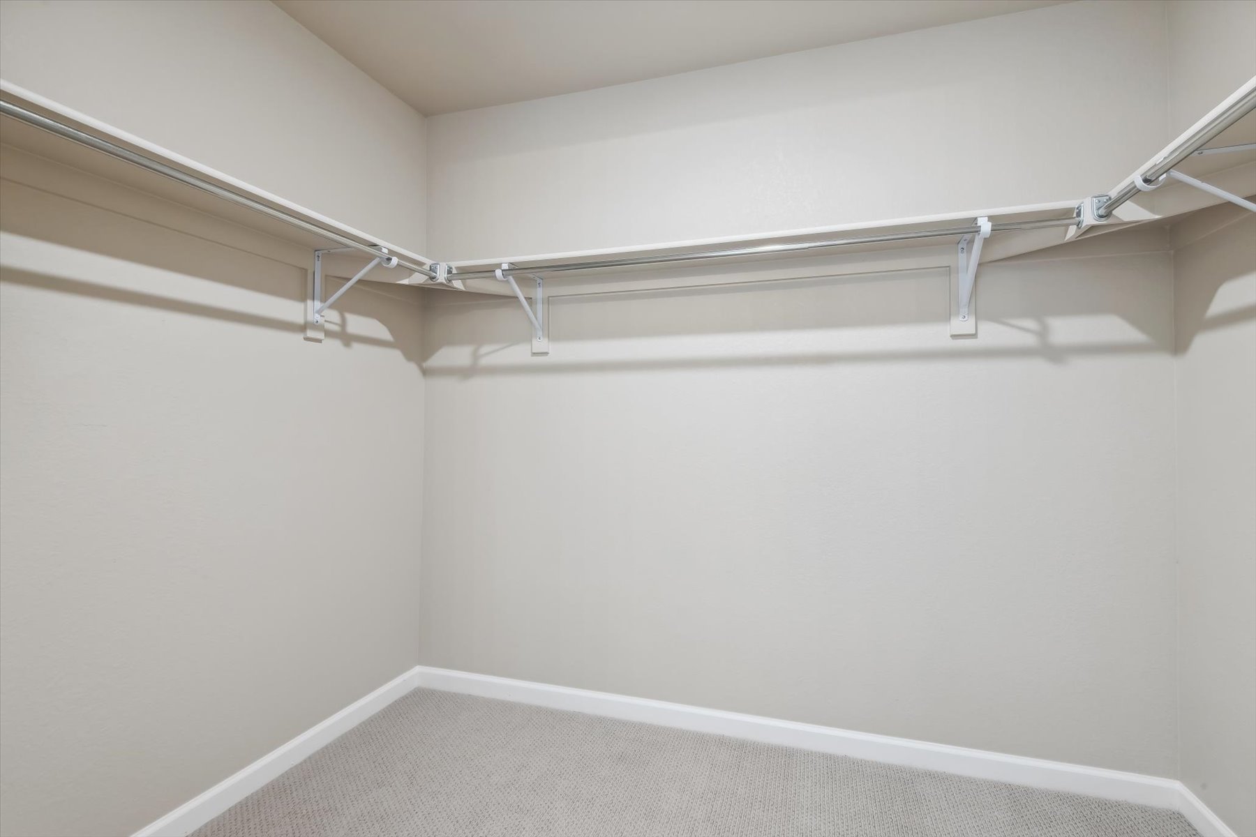 A white room with a metal railing.