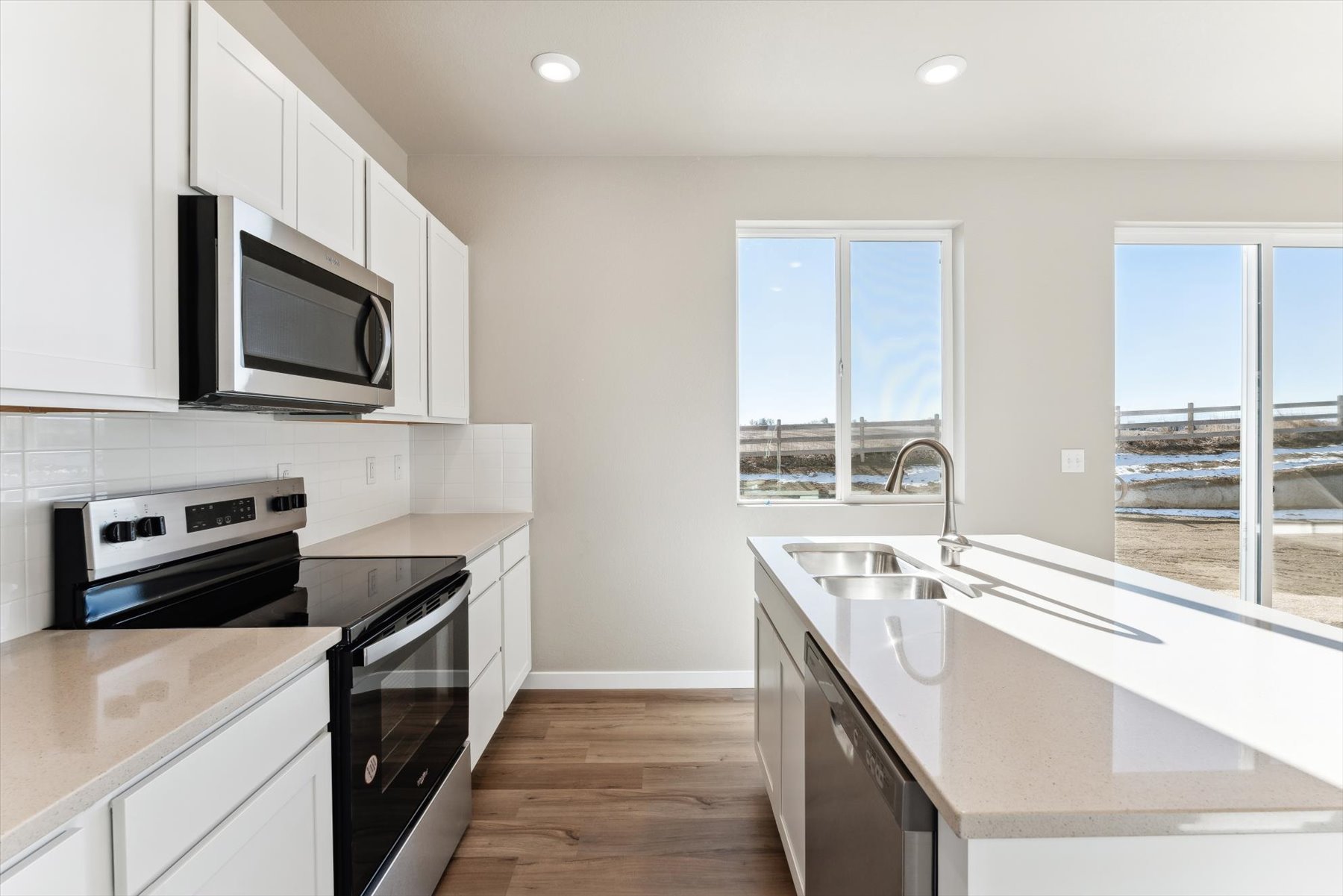 A kitchen with white cabinets.