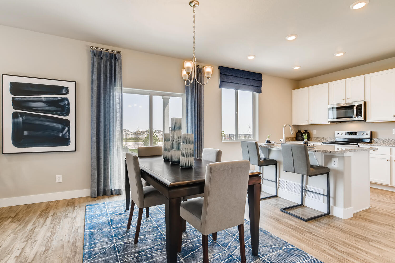 A kitchen with a dining table and chairs.