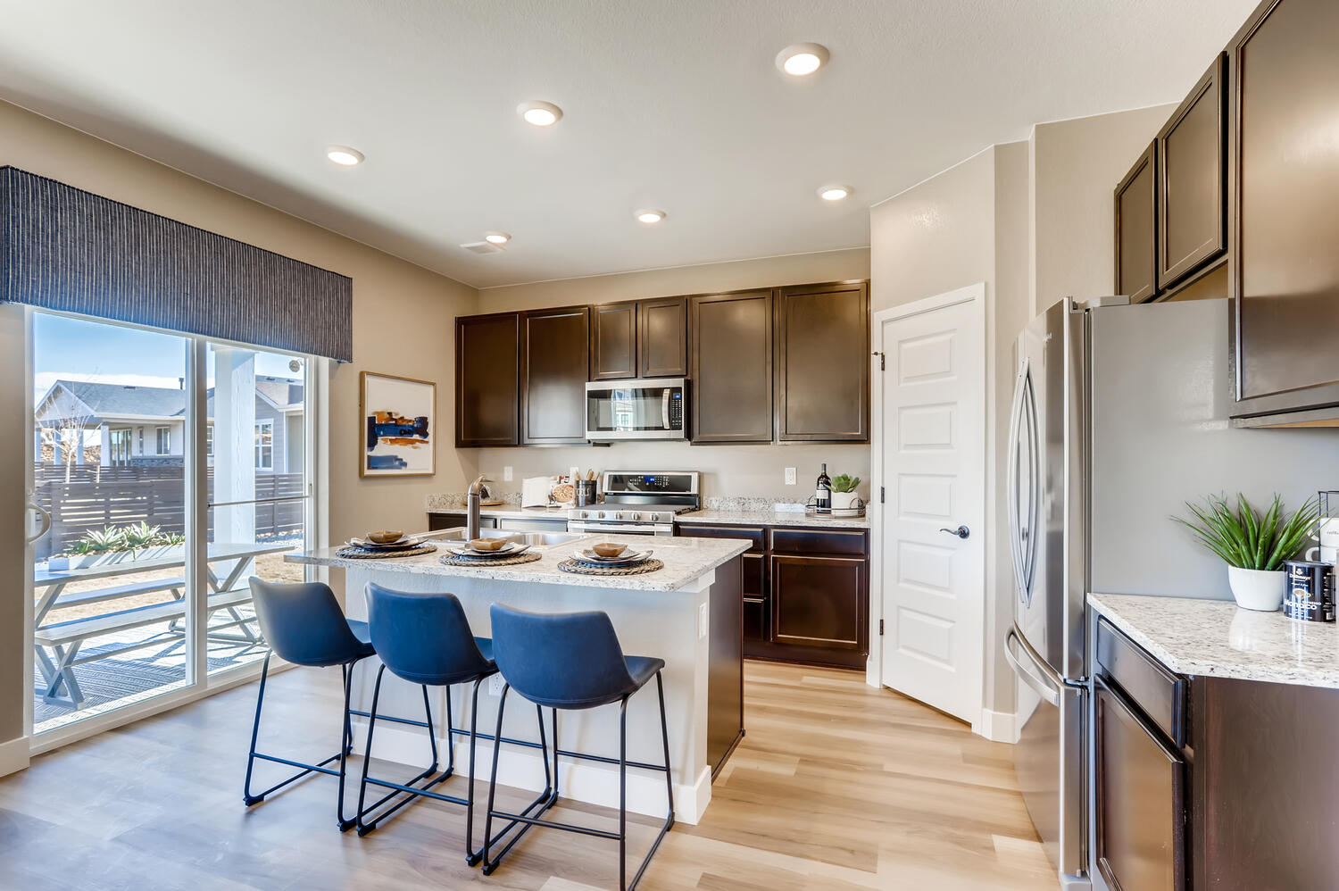 A kitchen with a table and chairs.