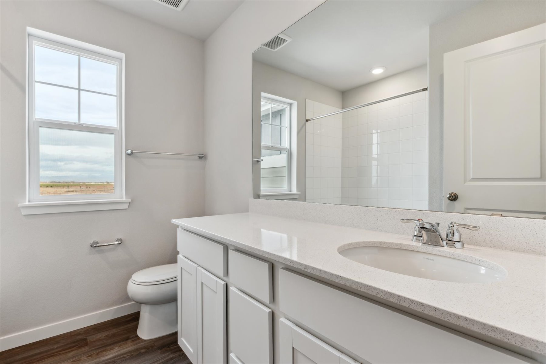 A bathroom with a large mirror.