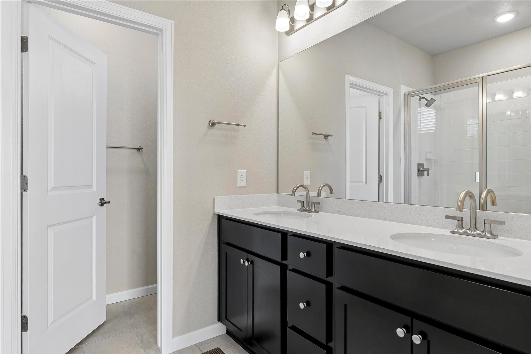 A bathroom with a large mirror.
