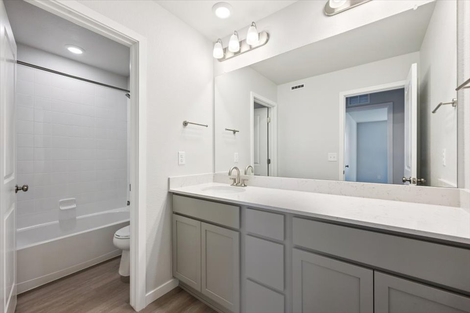 A bathroom with a large mirror.