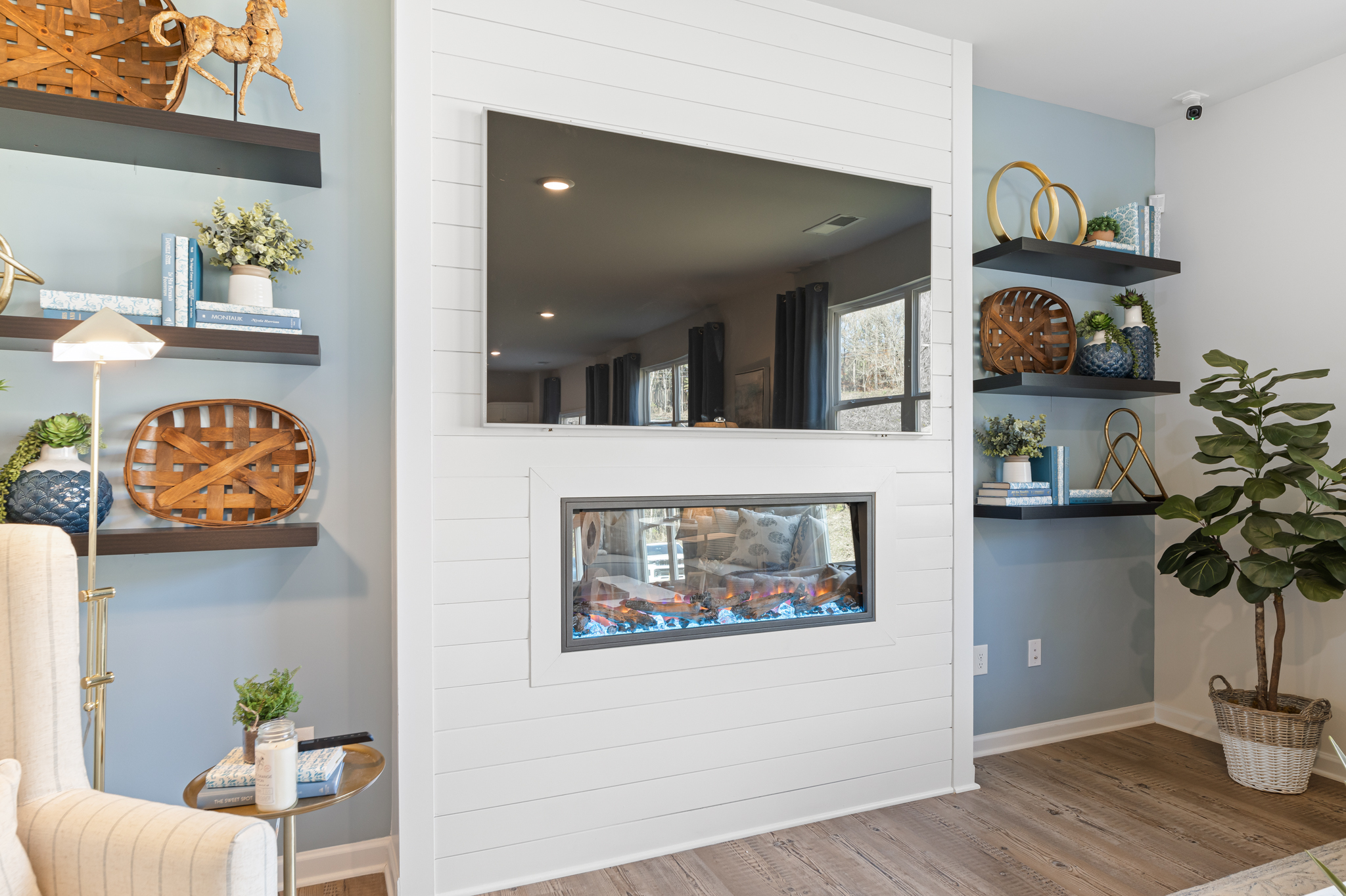 A room with a fireplace and a mirror.