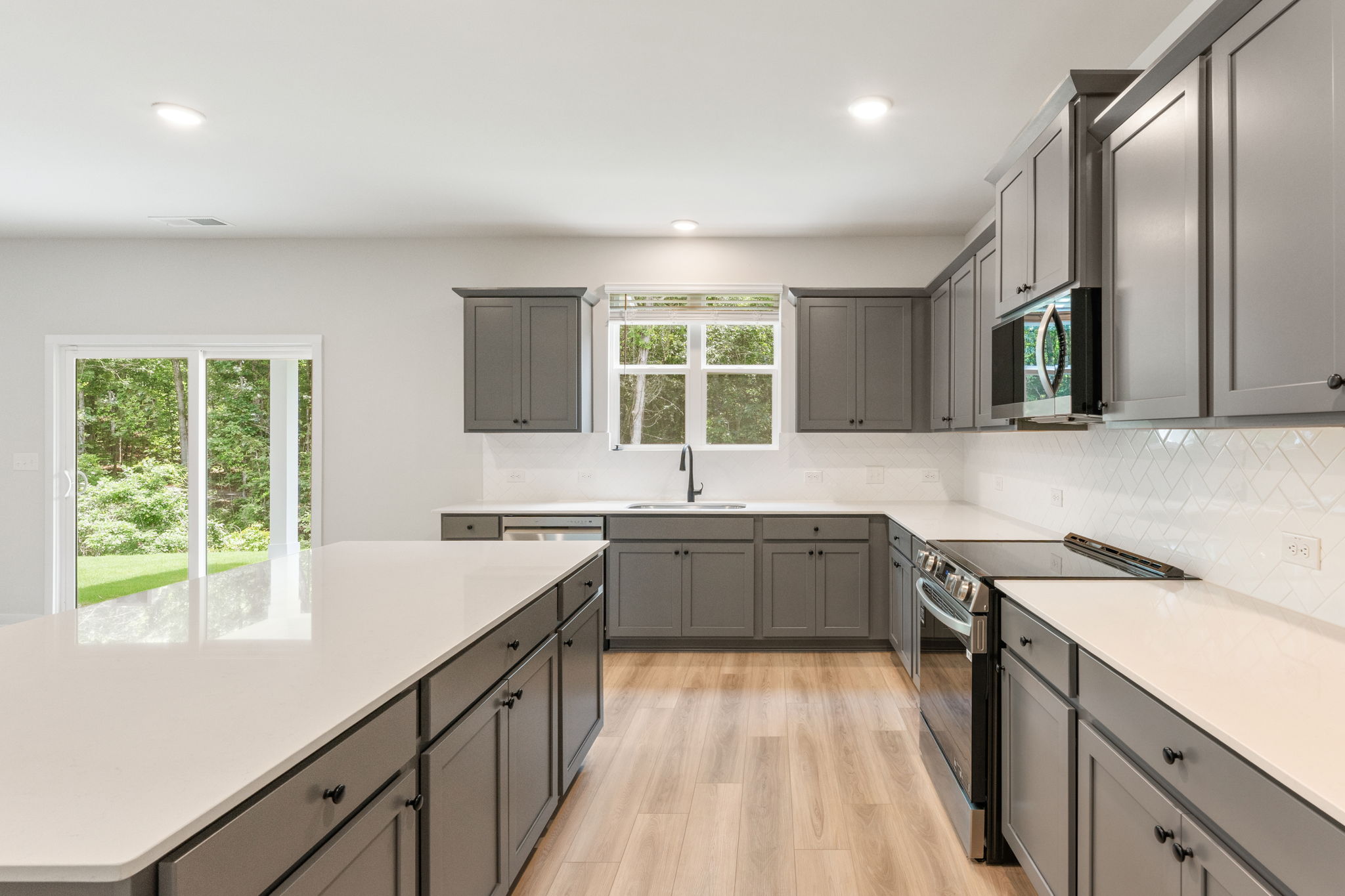 A kitchen with black cabinets.