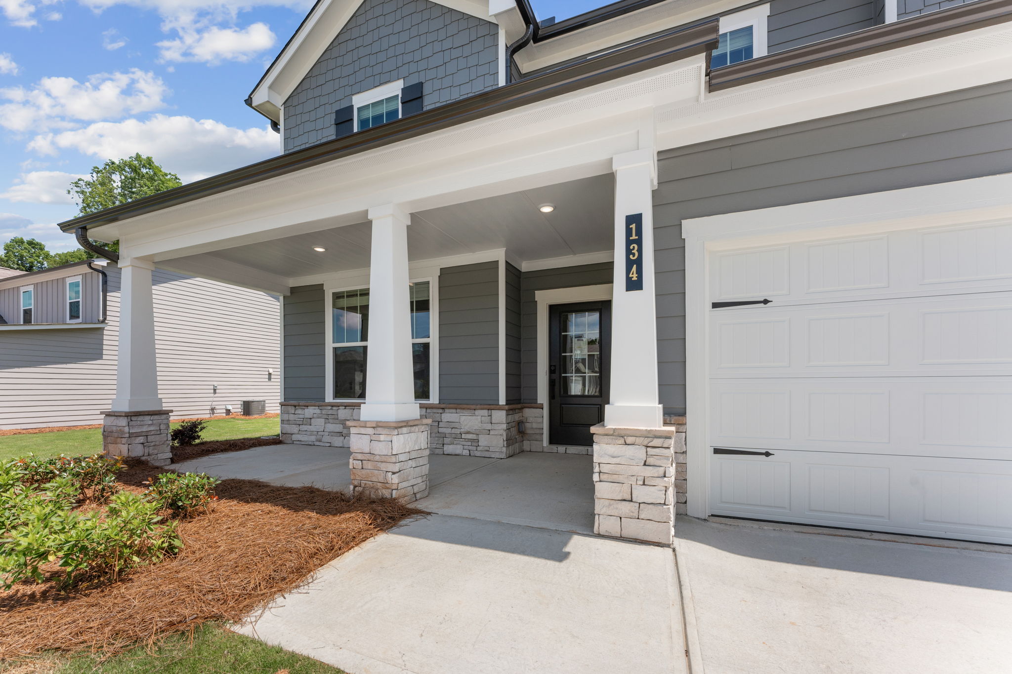 A white house with garages.