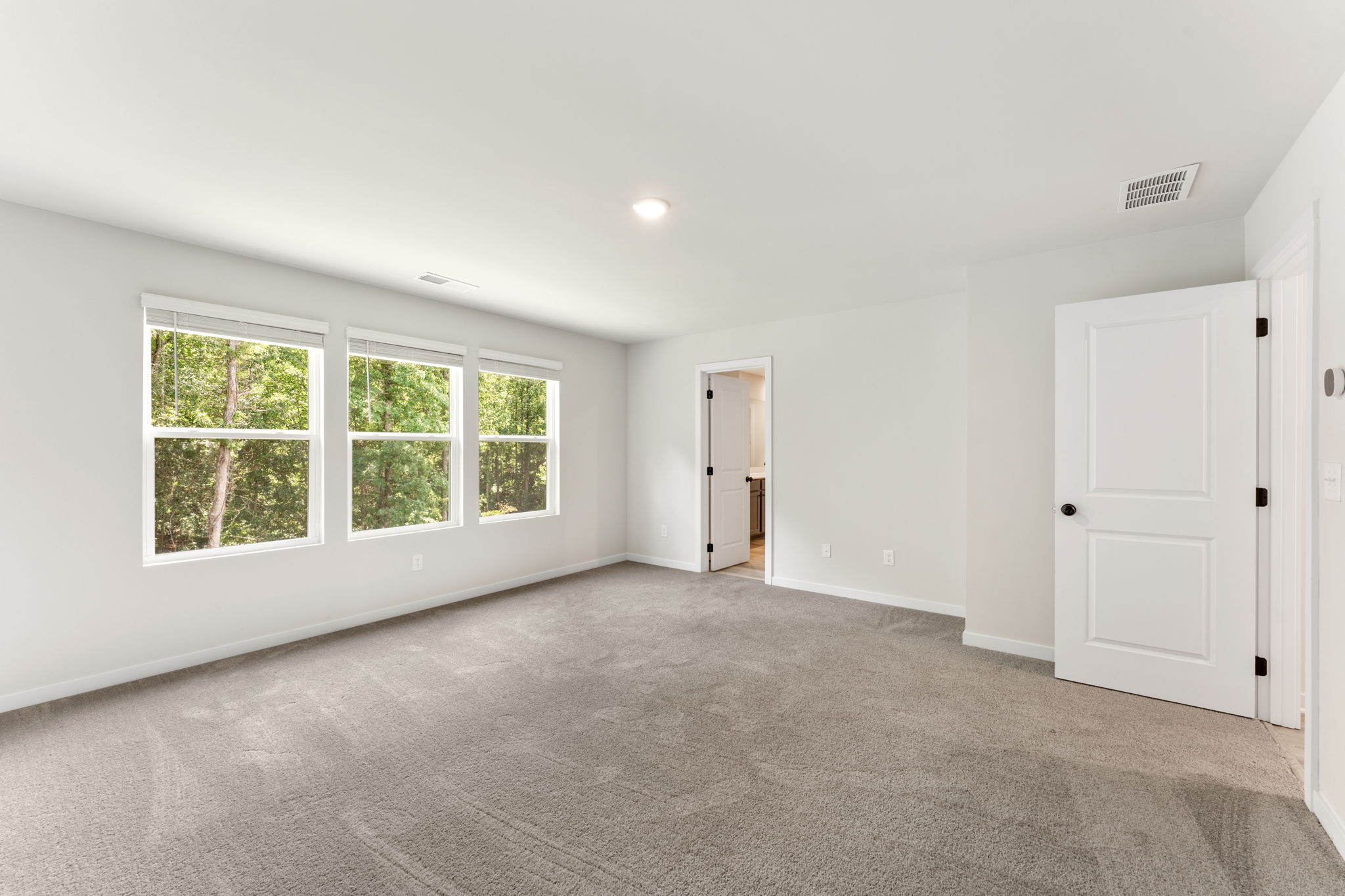 A room with white walls and a door.