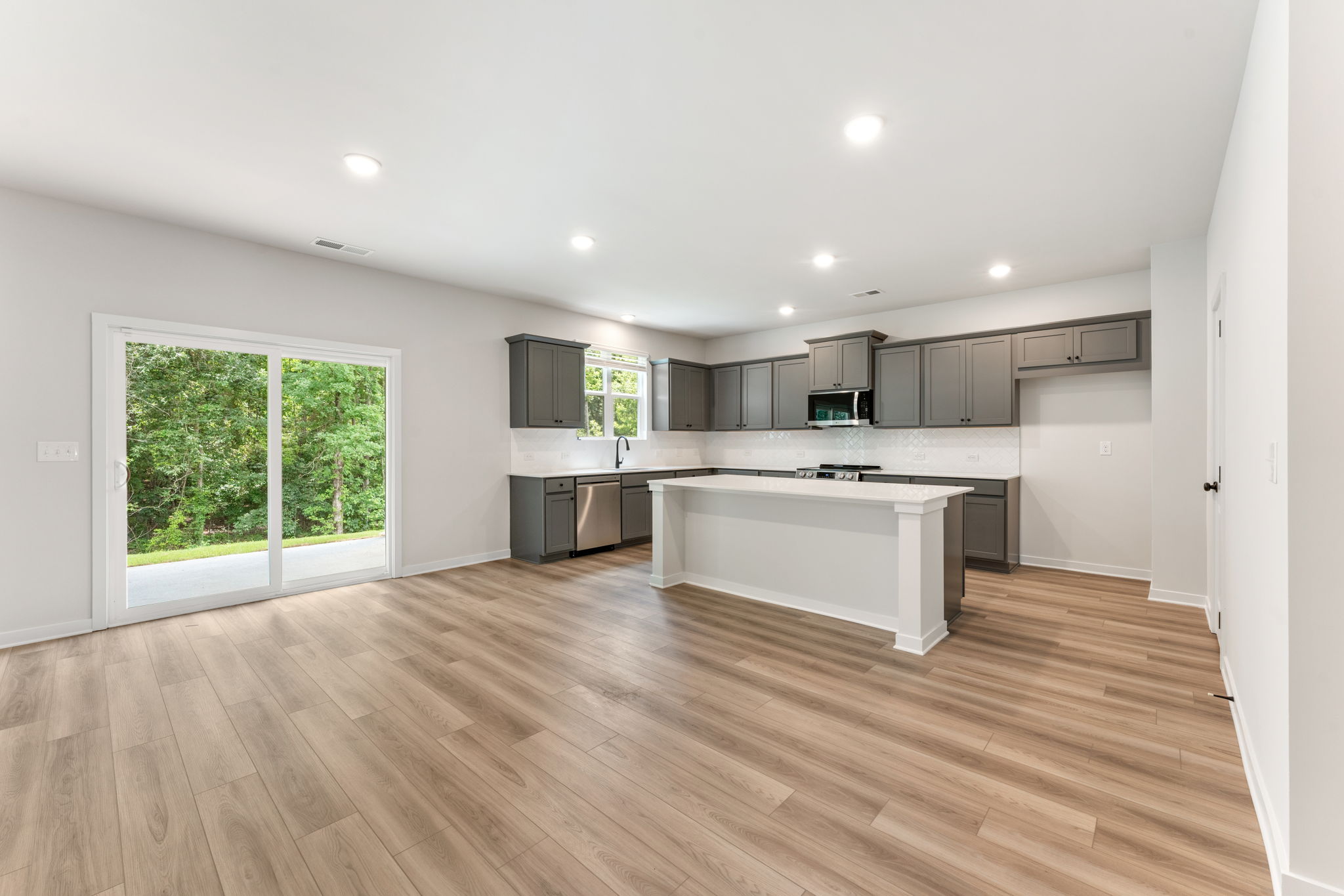 A kitchen with a wood floor.