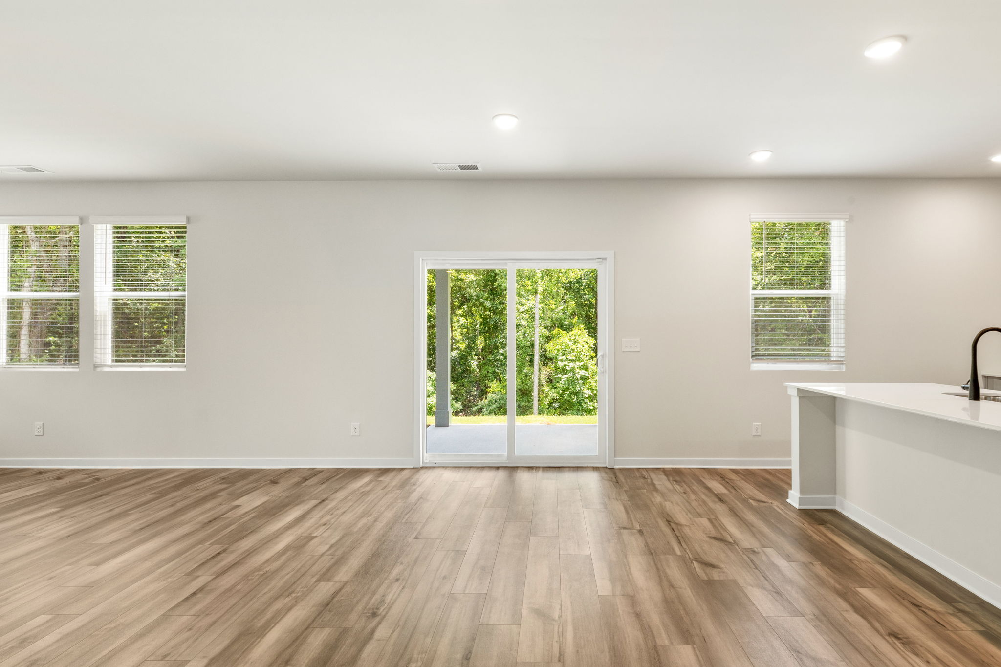 A room with a wood floor and windows.